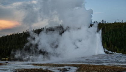 Old Faithful Eruption at Sunset