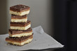 Millionaire's shortbread with chocolate and caramel. Copy space is on the right side. Selective focus.	