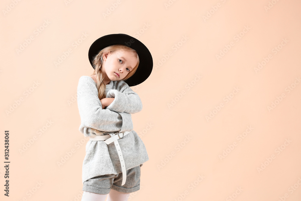 Cute little girl in autumn clothes on light background
