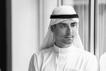 Wall Mural - Black and white portrait of Arab man near window