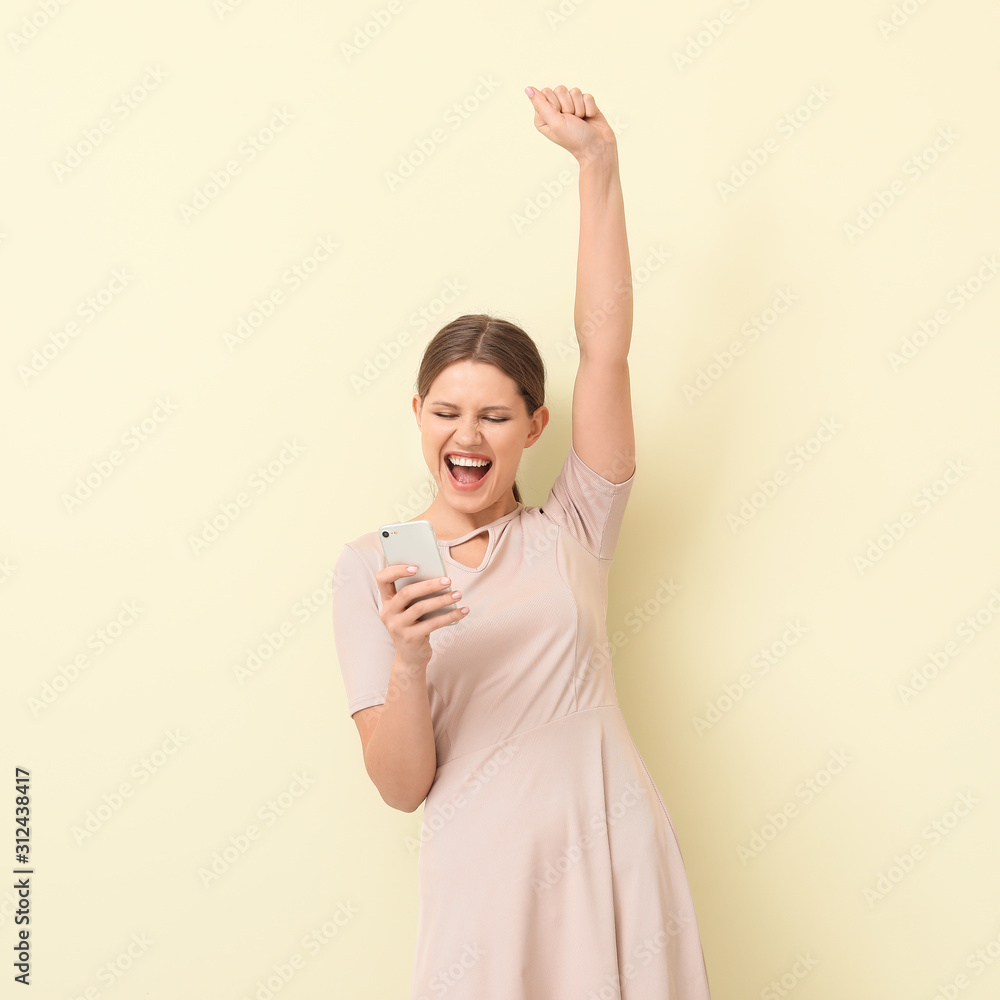Happy woman with mobile phone on color background