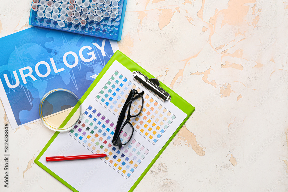 Paper sheet with text UROLOGY, test tubes and Petri dish on light background