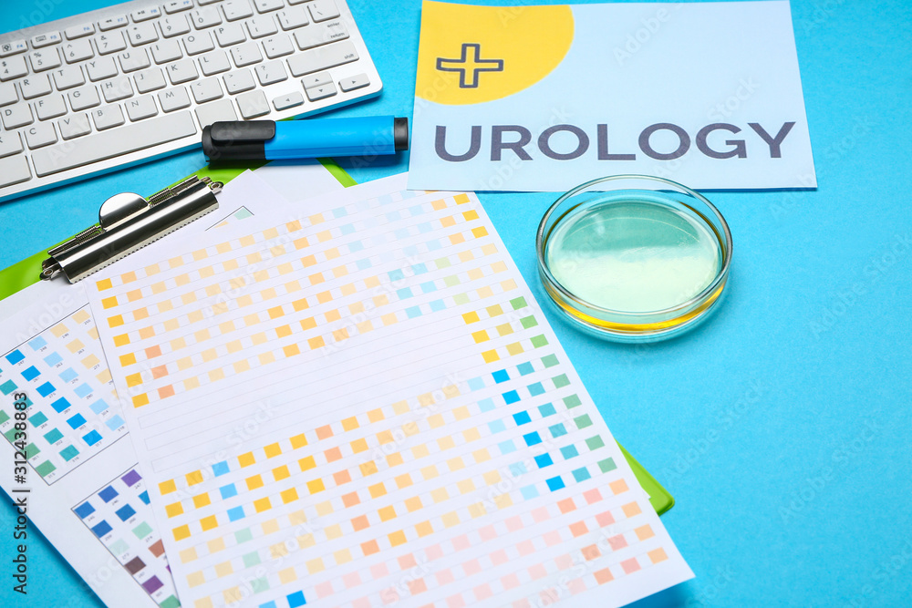 Paper sheet with text UROLOGY, Petri dish and PC keyboard on color background