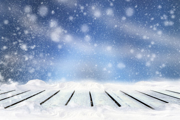 Poster - Greeting winter blurred background with wooden table and snowflakes