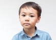 © donikz - Portrait of a child in a blue shirt on a white background