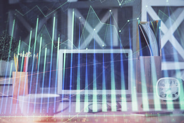 Forex market graph hologram and personal computer on background. Double exposure. Concept of investment.