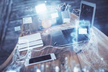 Desktop computer background in office and flying envelops hologram drawing. Multi exposure. Electronic mail concept.