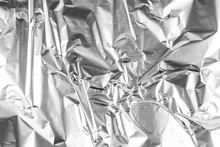 Close Up Of Aluminium Foil Crumpled. Silver Aluminium Foil Texture Background. Abstract Metallic Paper Pattern. Texture Of Crumpled Aluminum Kitchen Foil. Silver Abstract Background