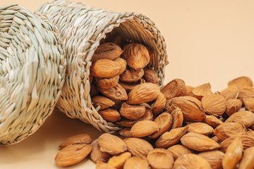 Wall Mural - Healthy organic dried almonds in a straw basket