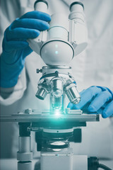 Wall Mural - close-up shot of microscope with metal lens.