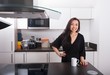 © MDBPIXS - Portrait of happy young woman with coffee mug in kitchen