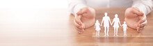 Family Care Concept. Hands With Paper Silhouette On Table.
