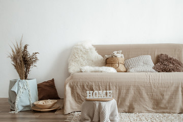 Wall Mural - The interior of the living room with a sofa and decorative items.