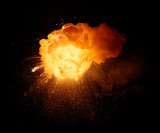 Fototapeta Łazienka - Fiery bomb explosion with sparks isolated on black background. Fiery detonation.