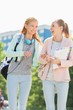 © MDBPIXS - Cheerful young female college students walking in campus