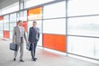 © MDBPIXS - Full length of businessmen with briefcase walking in railroad station