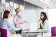 © MDBPIXS - Businesswoman explaining pie chart to colleagues in creative office