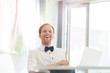 © MDBPIXS - Cheerful businessman sitting at desk in creative office