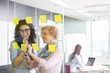 © MDBPIXS - Business women brainstorming with sticky notes in office