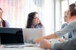 © MDBPIXS - Happy businesspeople discussing during meeting in creative office