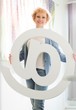 © MDBPIXS - Portrait of confident businesswoman holding at sign in creative office