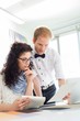 © MDBPIXS - Businesspeople discussing over samples at desk in creative office
