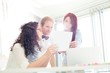 © MDBPIXS - Businesspeople discussing over photograph in creative office