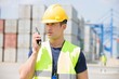© moodboard - Mid adult man using walkie-talkie in shipping yard