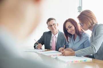 Wall Mural - Business people working together at conference table