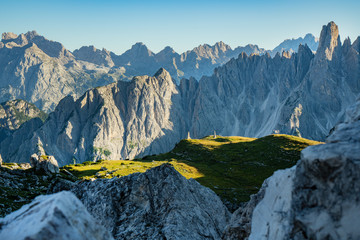 Panoramic view of famous Dolomites mountain peaks glowing in beautiful golden evening light at sunset in summer, South Tyrol, Italy