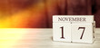 © Egor - Calendar reminder event concept. Wooden cubes with numbers and month on November 17 with sunlight.