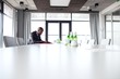 © MDBPIXS - Side view of young businessman sitting at conference table