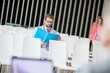© MDBPIXS - Businessman reading file while sitting in seminar hall at convention center