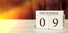 Calendar Reminder Event Concept. Wooden Cubes With Numbers And Month On December 9 With Sunlight.