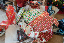 Piles Of Discarded Christmas Wrapping Paper Left On The Floor After Presents Have Been Opened.