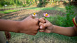 © Nabiru - Two-handed photo of friendship holding flowers