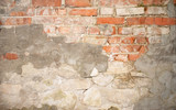 Fototapeta  - wall of old brick with remnants of plaster