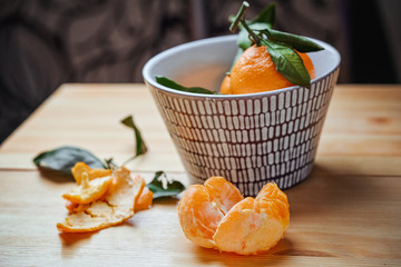 Wall Mural - Tangerines with leaves on rustic wooden background