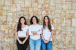 © guille Faingold/Stocksy - Adult and young women smiling at camera