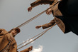 © Sergey Filimonov/Stocksy - Twins playing with rope against gray sky in countryside