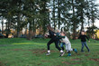 © Rob and Julia Campbell/Stocksy - Family football fun outside on the grass.