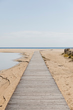 Wooden Walkway On The Beach That Goes Towards The Sea