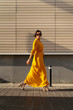© MEM Studio/Stocksy - Fashionable woman in yellow dress