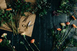 © Laura Stolfi/Stocksy - Working table with flowers and florist props on it seen from above