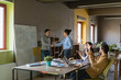 © Garage Island Crew/Stocksy - Young businesspeople celebrating success during a meeting