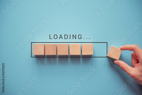 Cuadros en Lienzo Loading, hand putting wood cube in progress bar.