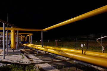 Wall Mural - Pipeline system at a gas production and processing plant. Pipes, valves, manometers. Night shooting