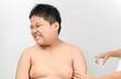 © kwanchaichaiudom - Fat boy afraid of syringe turning his head away squeezing eyes in fear.