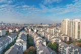 Fototapeta Paryż - Cityscape of residential house rooftop and skyscraper