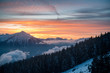 colorful winter sunset with Mount Niesen, clouds and forest